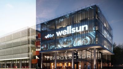 Office building with a Wellsun Lumiduct façade lit up at dusk